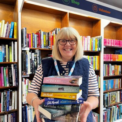 Shop volunteer holding books