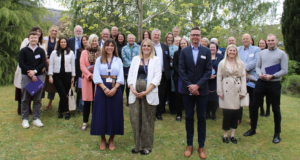 Group photograph of attendees at St Giles Hospice's Spring Celebration lunch, May 2026.