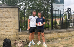 James Lewis, 26, from Rugeley, pictured with Sam Colclough, Senior Events Officer at St Giles Hospice, as he dribbles a football towards Coventry during the final stretch of his 2,000 mile fundraising challenge from Marrakech to Staffordshire.