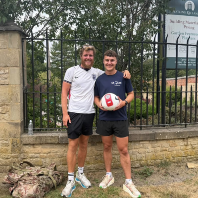 James Lewis, 26, from Rugeley, pictured with Sam Colclough, Senior Events Officer at St Giles Hospice, as he dribbles a football towards Coventry during the final stretch of his 2,000 mile fundraising challenge from Marrakech to Staffordshire.
