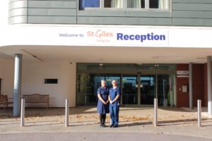 Ruth Abell and Samantha Doody standing side by side in front of St Giles Hospice